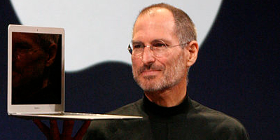 Steve Jobs holding laptop